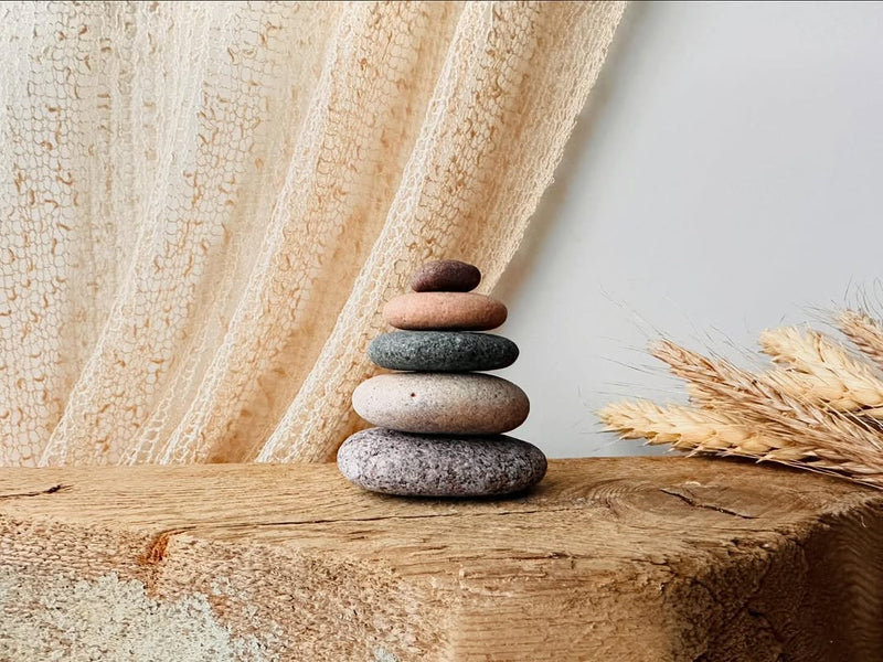 Stone cairn on a neutral bedroom shelf